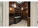 Spacious walk-in closet with custom wood cabinets, hanging lights and drawers, providing ample storage space at 2522 Habersham Nw Rd, Atlanta, GA 30305