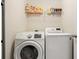 Laundry room with washer, dryer, and storage shelving at 4133 Royal Regency Nw Cir, Kennesaw, GA 30144