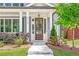 Welcoming front porch with a wooden door and white columns at 510 Oak Dr, Hapeville, GA 30354