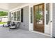 Covered porch with two wicker chairs and a side view of the front door at 510 Oak Dr, Hapeville, GA 30354