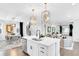 Open concept kitchen and Gathering room with island, hardwood floors, and stylish light fixtures at 510 Oak Dr, Hapeville, GA 30354