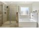 Bathroom with walk-in shower and separate soaking tub at 13136 Vista Ln, Covington, GA 30014