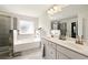 Double vanity bathroom with soaking tub and walk-in shower at 13136 Vista Ln, Covington, GA 30014
