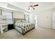 Main bedroom with king bed, ensuite bathroom access, and ceiling fan at 13136 Vista Ln, Covington, GA 30014