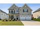 Two-story house with gray siding, white trim, and a three-car garage at 13136 Vista Ln, Covington, GA 30014