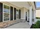Front porch with brick accents and white columns at 13136 Vista Ln, Covington, GA 30014