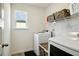 Bright laundry room with washer, dryer, and shelving at 13136 Vista Ln, Covington, GA 30014