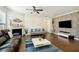 Living room with fireplace, hardwood floors, and two sofas at 13136 Vista Ln, Covington, GA 30014