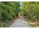Paved walking trail winds through lush trees at 13136 Vista Ln, Covington, GA 30014