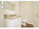 Clean bathroom with granite vanity, updated toilet, and vinyl flooring at 3218 Ward Sw Dr, Atlanta, GA 30354