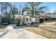 Brick ranch home with driveway, mature trees, and grassy yard at 3218 Ward Sw Dr, Atlanta, GA 30354