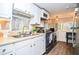 Kitchen with white cabinets and black appliances at 135 Marina Ct, Canton, GA 30114