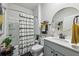 Well-lit bathroom featuring a shower-tub combination, modern fixtures, and stylish decor for a spa-like experience at 251 Ivy Chase Loop, Dallas, GA 30157