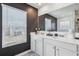 Well-lit bathroom with double vanity and a dark gray accent wall at 251 Ivy Chase Loop, Dallas, GA 30157