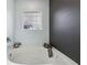 Bathroom featuring a relaxing soaking tub with a dark gray accent wall at 251 Ivy Chase Loop, Dallas, GA 30157