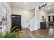 Welcoming entryway with wood floors, coat rack, and staircase leading to the upper level at 251 Ivy Chase Loop, Dallas, GA 30157