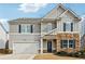 Charming two-story home with stone accents, a two-car garage, and beautiful curb appeal at 251 Ivy Chase Loop, Dallas, GA 30157