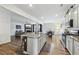 Bright, open kitchen featuring an island with bar seating, modern appliances, and views to living areas at 251 Ivy Chase Loop, Dallas, GA 30157