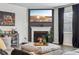Cozy living room with a fireplace, modern decor, and hardwood floors, perfect for relaxing and entertaining at 251 Ivy Chase Loop, Dallas, GA 30157