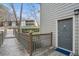 Exterior entryway with gray siding, front door, and wooden deck at 2901 Lenox Ne Rd # 506, Atlanta, GA 30324