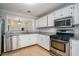 Well-lit kitchen with stainless steel appliances, granite countertops, and white cabinets at 2901 Lenox Ne Rd # 506, Atlanta, GA 30324