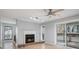 Living room with a fireplace, fan, and sliding glass doors to a balcony at 2901 Lenox Ne Rd # 506, Atlanta, GA 30324