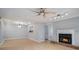 Open floor plan with light wood flooring, fireplace, fan, and modern lighting at 2901 Lenox Ne Rd # 506, Atlanta, GA 30324