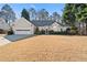 House exterior showcasing a manicured lawn and attached garage at 6055 Song Breeze Trce, Johns Creek, GA 30097