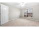 A bright and airy bedroom with neutral carpet, a ceiling fan, and a window with blinds at 2650 Hamilton Chase Run, Buford, GA 30519