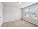 Bright bedroom featuring carpet flooring and a large window at 320 Eagles Pkwy, Covington, GA 30014