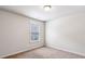 Simple bedroom with neutral walls, carpeting, and a window at 320 Eagles Pkwy, Covington, GA 30014