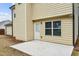 Ground-level patio with adjacent exterior door and window at 320 Eagles Pkwy, Covington, GA 30014