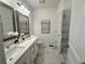 Elegant bathroom featuring double sinks, marble floors, and a glass-enclosed shower at 534 Sawnee Village Blvd # D65, Cumming, GA 30040