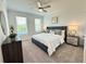 Relaxing bedroom with neutral tones, large windows, a ceiling fan, and plush carpeting at 534 Sawnee Village Blvd # D65, Cumming, GA 30040