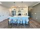 A modern kitchen island with white countertop and bar stools is illuminated by stylish pendant lights above at 534 Sawnee Village Blvd # D65, Cumming, GA 30040