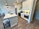 Modern kitchen showcasing white cabinets, stainless steel appliances, and a functional island with bar seating at 534 Sawnee Village Blvd # D65, Cumming, GA 30040