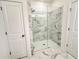 Contemporary shower with marble-style tile, glass doors, and modern fixtures at 534 Sawnee Village Blvd # D65, Cumming, GA 30040