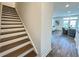 Elegant staircase connecting multiple levels of the home, with natural light and views of the living area at 534 Sawnee Village Blvd # D65, Cumming, GA 30040