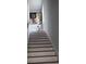 Bright, clean staircase with wall art and a vase of flowers at 857 Proctor Nw St, Atlanta, GA 30314