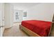 Cozy bedroom with red bedding and neutral walls at 1000 Belfry Ter, Fairburn, GA 30213