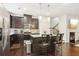 Kitchen with dark brown cabinets, granite countertops, and island with seating at 1000 Belfry Ter, Fairburn, GA 30213