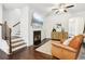 Living room with hardwood floors, fireplace, and stairs to upper level at 1000 Belfry Ter, Fairburn, GA 30213