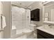 Modern bathroom with marble shower, dark vanity, and built-in shelving at 1211 Grand View Se Dr, Mableton, GA 30126