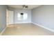 Bright bedroom with ceiling fan, mirror, and light grey walls at 1211 Grand View Se Dr, Mableton, GA 30126