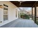 Covered deck with ceiling fan, wood accents, and cable railing at 1211 Grand View Se Dr, Mableton, GA 30126