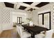 Bright dining room with a view into the living room, features a large table and black and white geometric wallpaper at 1211 Grand View Se Dr, Mableton, GA 30126