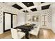 Elegant dining room features black and white geometric wallpaper, coffered ceiling, and a dark wood table at 1211 Grand View Se Dr, Mableton, GA 30126