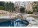 Relaxing stone spa with waterfall feature and lush landscaping at 1211 Grand View Se Dr, Mableton, GA 30126