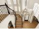 Grand staircase with wrought iron railing and chandelier at 1211 Grand View Se Dr, Mableton, GA 30126