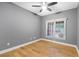 Neutral bedroom featuring hardwood floors, ceiling fan, and natural light at 211 Colonial Homes Nw Dr # 1105, Atlanta, GA 30309